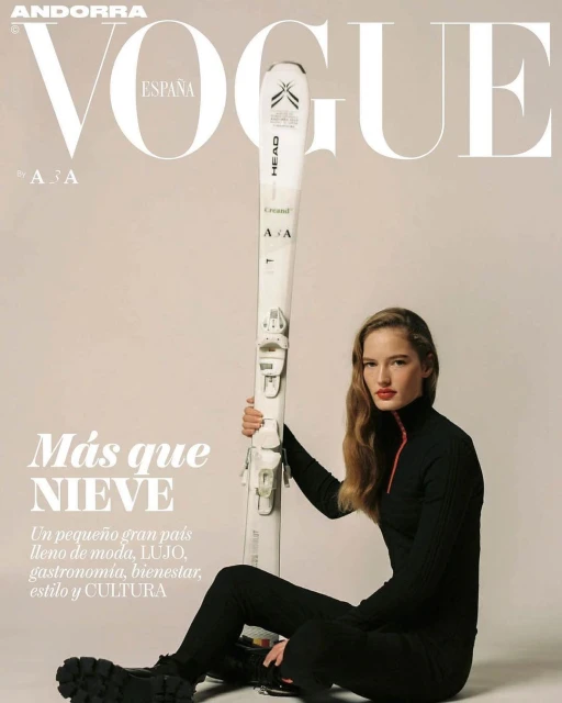Vogue España cover featuring a woman in black athletic wear holding a pair of skis, in a studio setting with text overlays.
