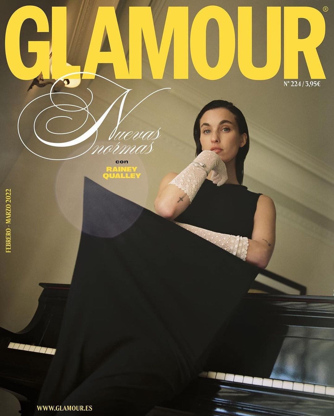 Glamour magazine cover featuring Rainey Qualley in a black dress and sheer gloves, seated beside a black grand piano indoors.