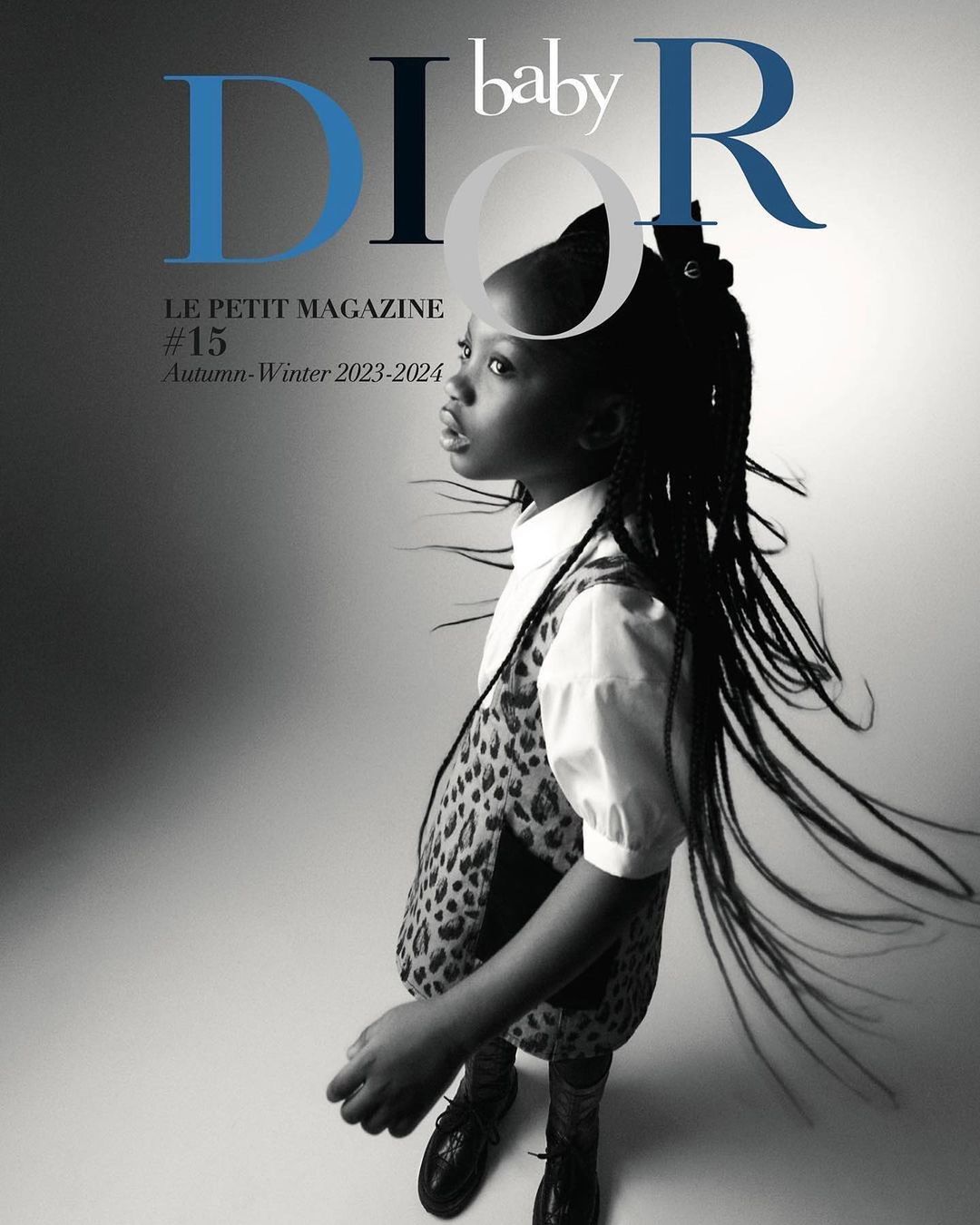 Young girl in leopard-print dress on Dior Baby magazine cover, in studio with blue and black text, Autumn-Winter 2023-2024 issue.