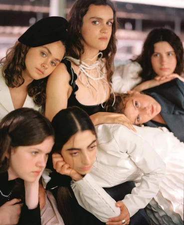 Group portrait of six young women posing closely together in a styled editorial fashion composition by Pablo Zamora.