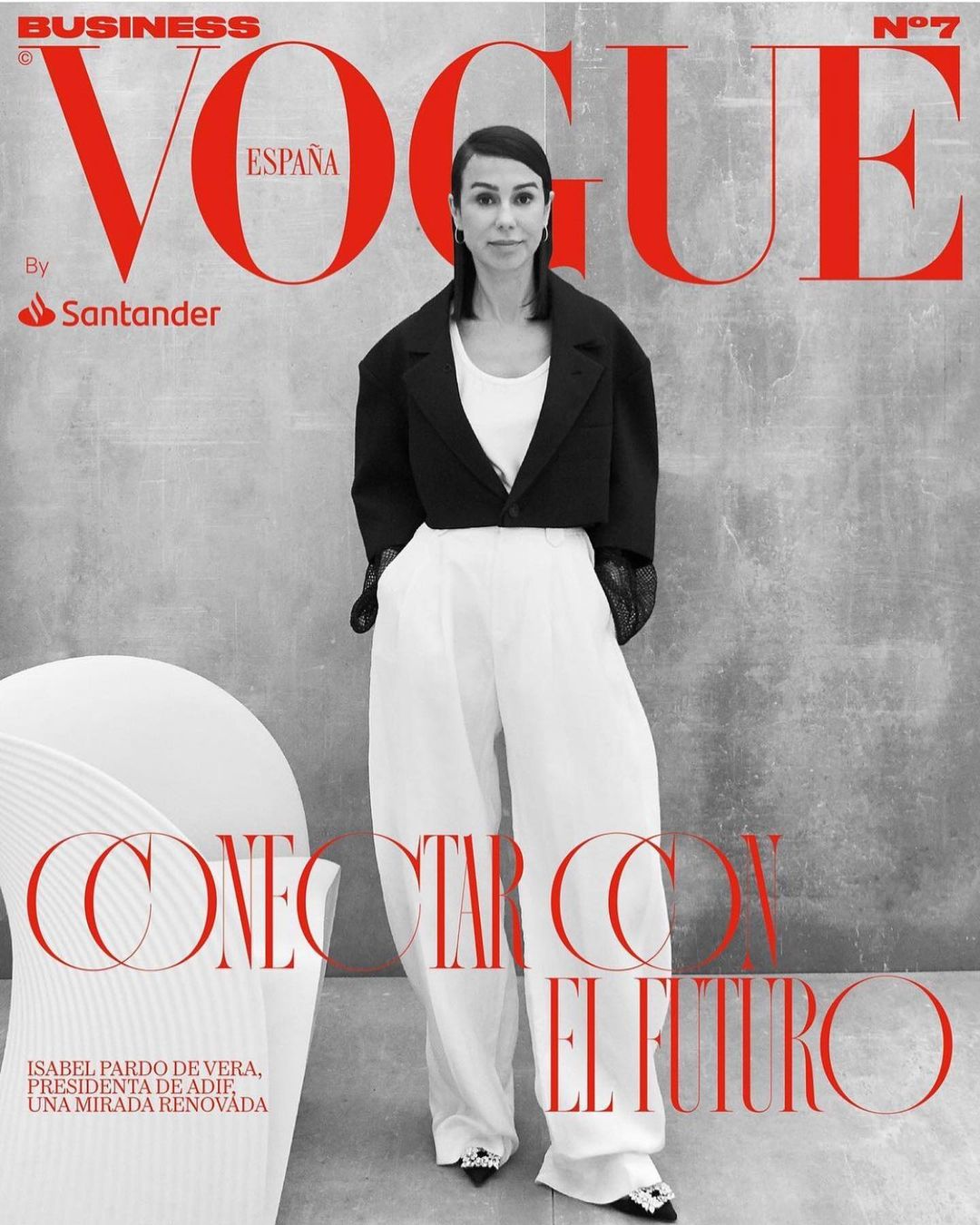 Vogue España business cover featuring Isabel Pardo de Vera in black jacket and white pants, standing against gray background.