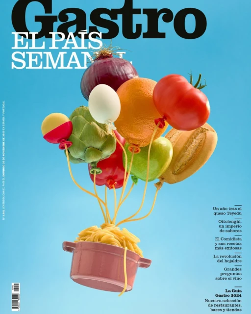 Magazine cover features fresh food ingredients styled as balloons over a pot of spaghetti against a light blue background. Culinary theme.