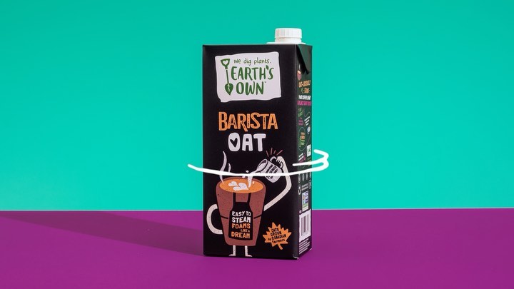 Earth's Own barista oat carton on a vibrant two-tone teal and purple surface, showcasing minimalist design and a clean product shot.