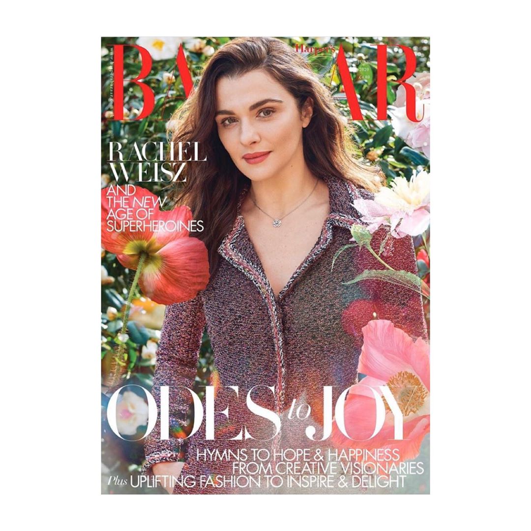 Magazine cover featuring Rachel Weisz in tweed jacket among pink and white flowers. Bazaar logo in top left corner. Close-up shot.