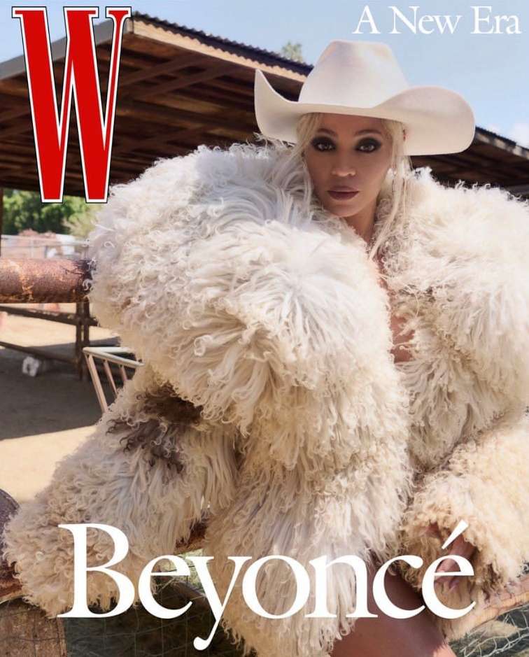 W Magazine cover featuring Beyoncé wearing a white cowboy hat and furry coat, posing in front of a rural outdoor setting.