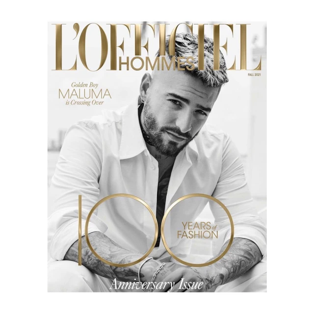 L'Officiel Hommes magazine cover featuring Maluma in white shirt and seated pose against soft-focus background. Gold text overlay.
