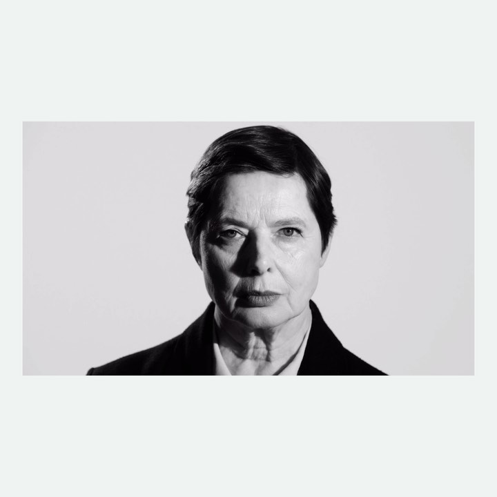 Portrait of an older woman with short dark hair in a black blazer against a plain white background by Paola Kudacki