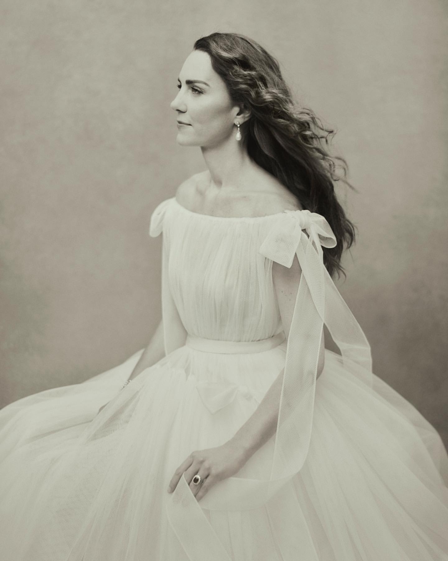 Profile portrait of Catherine, Princess of Wales wearing an off-shoulder white tulle gown by Paolo Roversi.