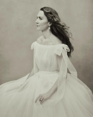 Profile portrait of Catherine, Princess of Wales wearing an off-shoulder white tulle gown by Paolo Roversi.