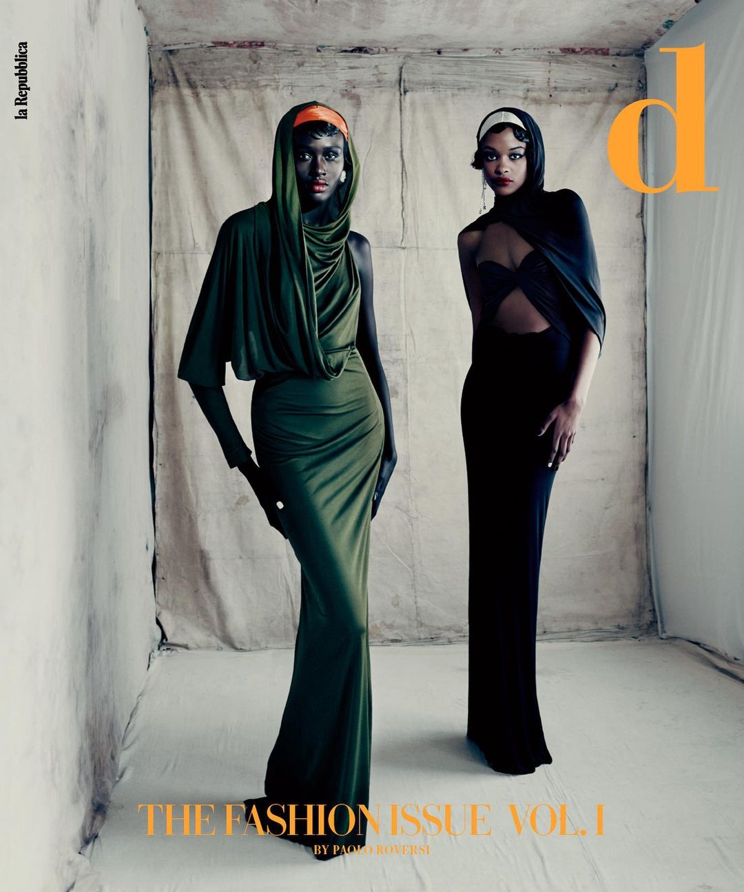 Two women in elegant gowns pose in a studio setting, highlighted by natural light. Fashion editorial featuring a vintage-inspired aesthetic.
