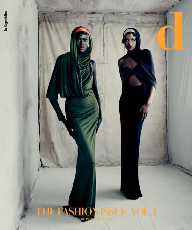 Two women in elegant gowns pose in a studio setting, highlighted by natural light. Fashion editorial featuring a vintage-inspired aesthetic.