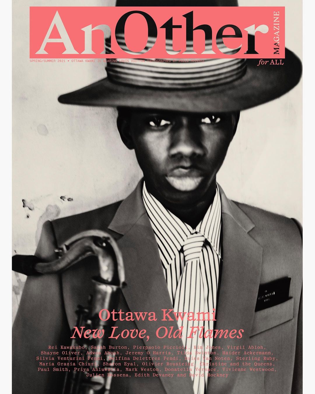 Portrait of Ottawa Kwami wearing a fedora hat and tailored suit holding a saxophone by photographer Paolo Roversi