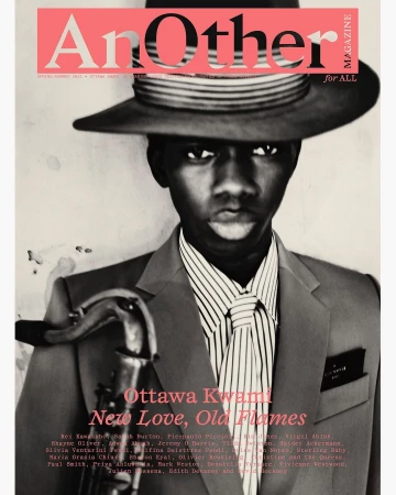 Portrait of Ottawa Kwami wearing a fedora hat and tailored suit holding a saxophone by photographer Paolo Roversi