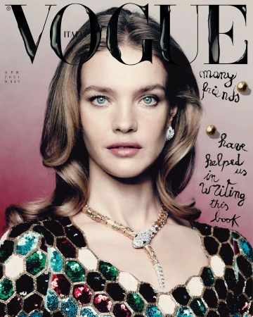 Vogue Italia cover featuring a blonde woman with blue eyes wearing a colorful sequined dress and Bulgari jewelry against a pink backdrop.