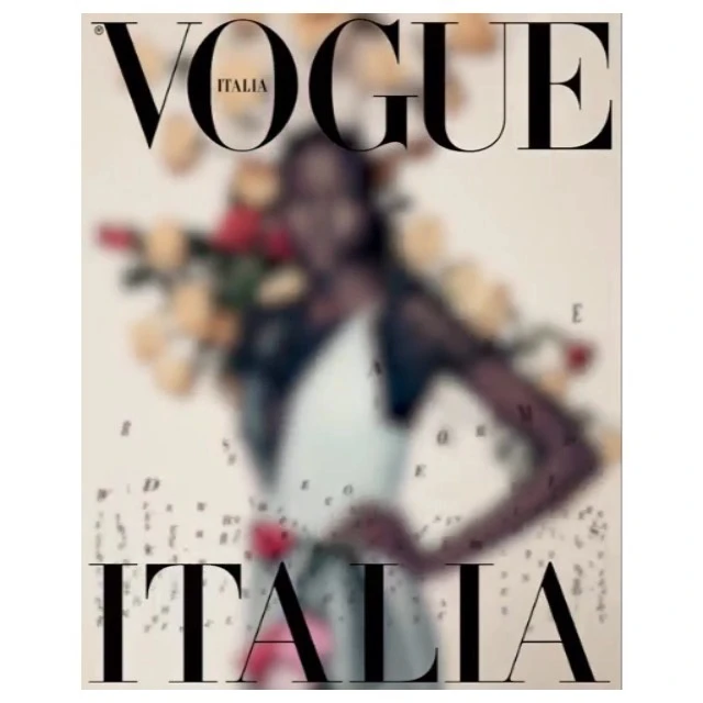 Vogue Italia cover featuring a blurred image of a Black model holding flowers, with the magazine's name prominently displayed.