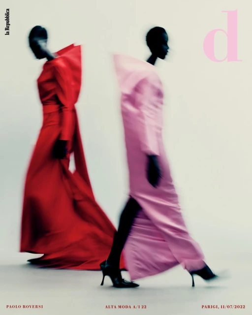 Two fashion models in gowns walking, blurred motion effect, monochromatic colors, light background, studio lighting. Editorial fashion photography.