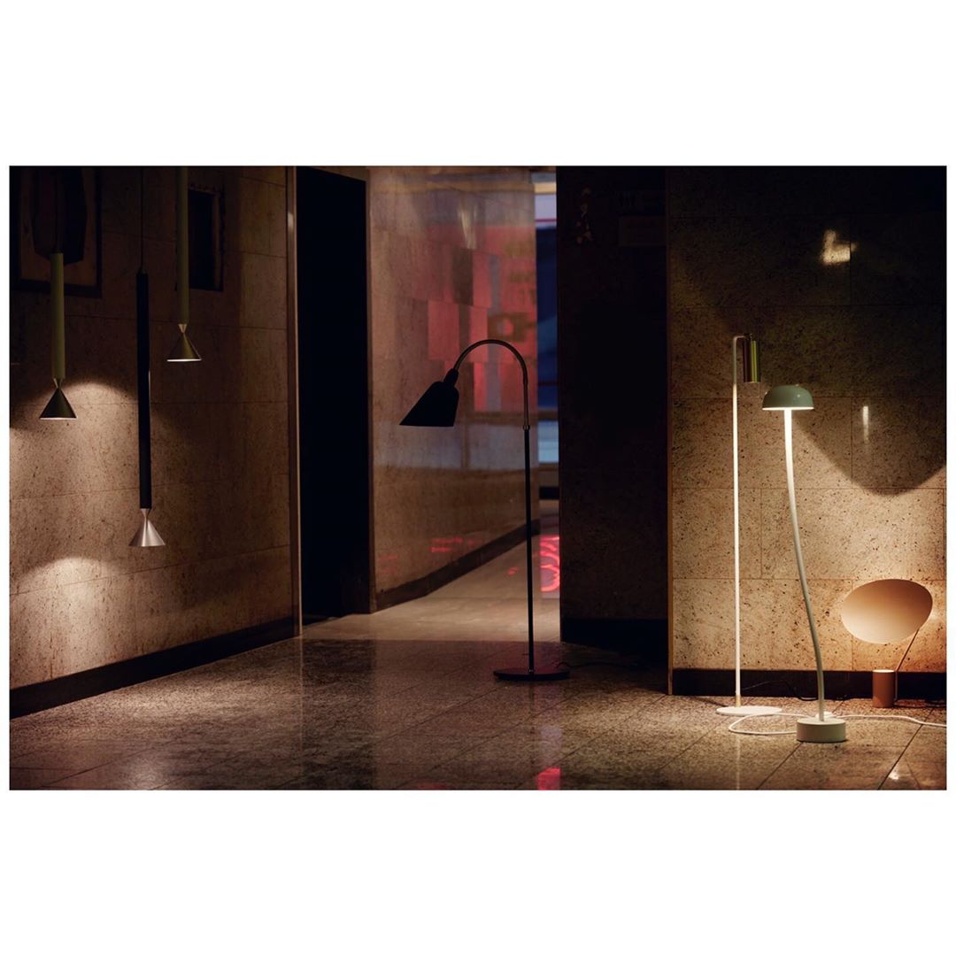 Illuminated interior corridor featuring modern floor and hanging lamps, enhancing the ambiance with warm and indirect lighting.