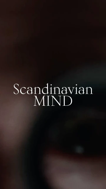 Close up vertical image of an eye with the text 'Scandinavian MIND' overlaid on it. The background is dark and blurry.