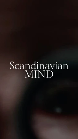 Close up vertical image of an eye with the text 'Scandinavian MIND' overlaid on it. The background is dark and blurry.