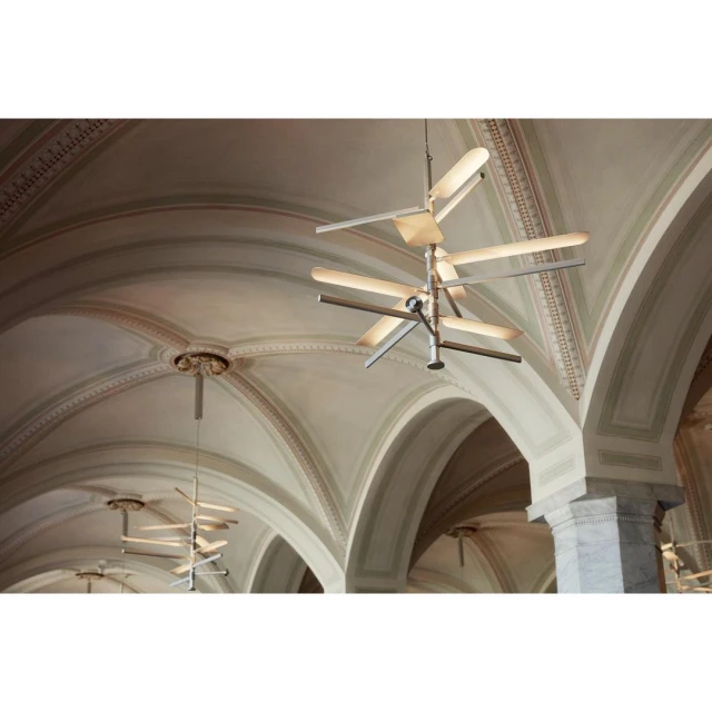 Interior view of a room with vaulted ceilings and columns, showcasing several modern chandeliers hanging from the ceiling.
