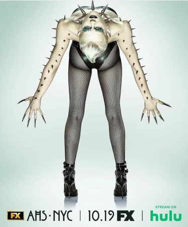 Promotional image for American Horror Story: NYC features a human with long black nails wearing a spiked collar and high-heeled boots.