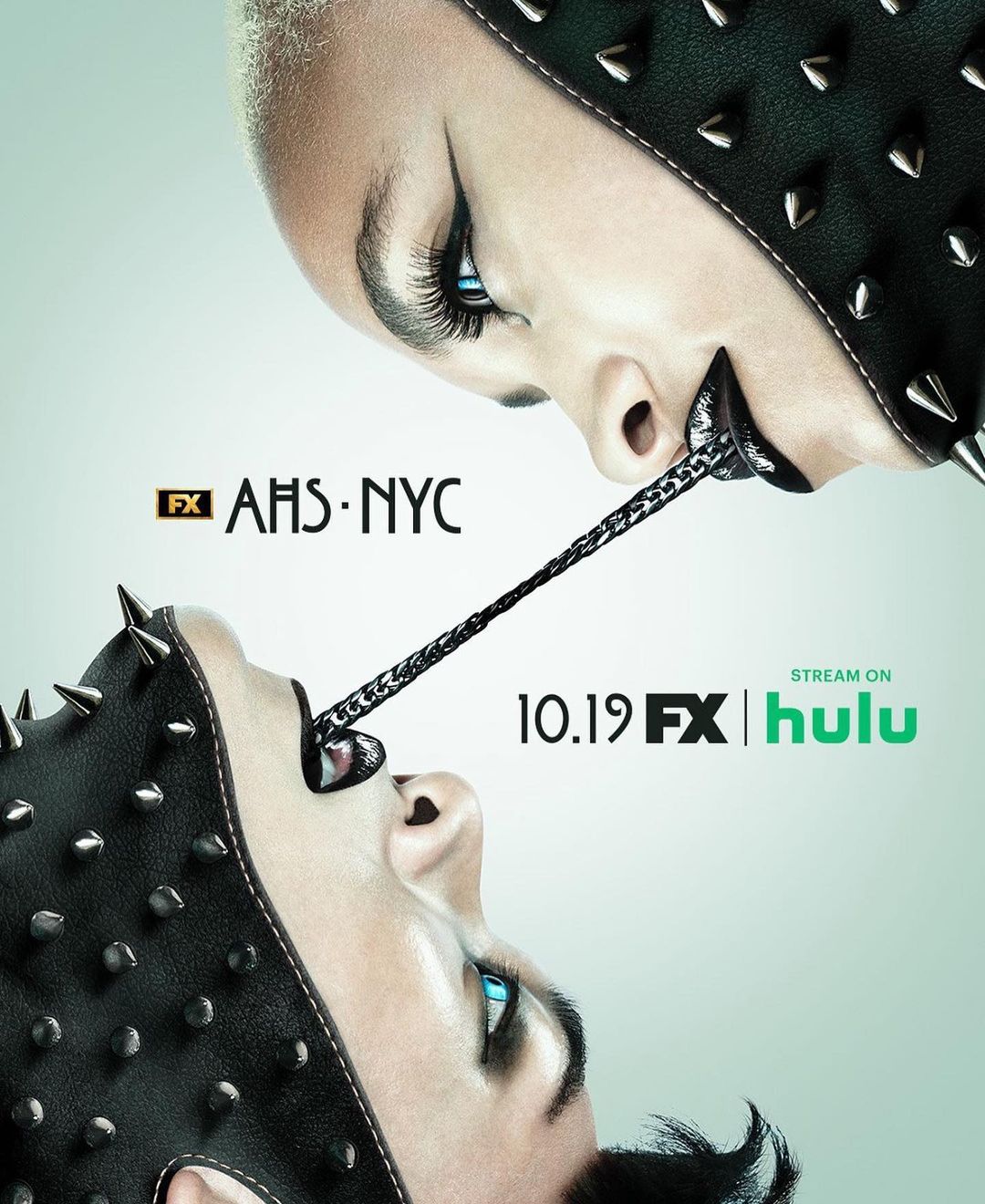 Promotional image for American Horror Story: NYC featuring close-up of two people with pale skin, dark eye makeup, and spiked leather headgear.