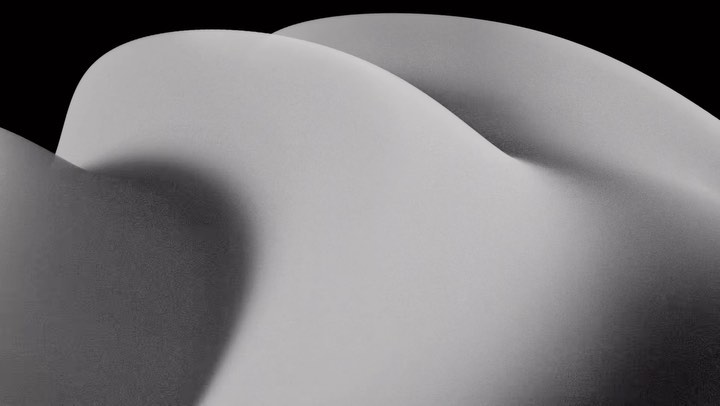 Abstract flowing shapes in shades of grey against a stark black background, creating a minimalist and modern graphic composition.