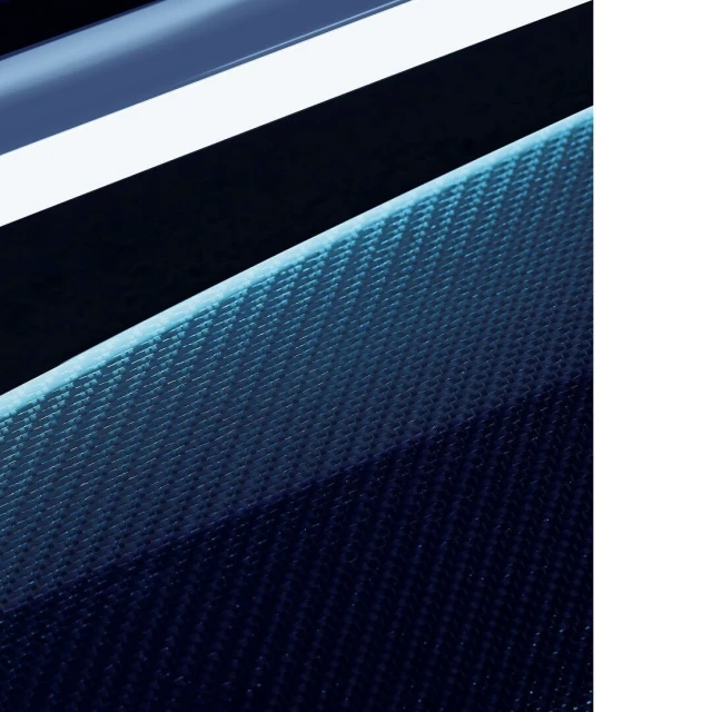 Abstract close-up of dark blue carbon fiber material with a bright blue neon light strip above it creating an angled perspective.