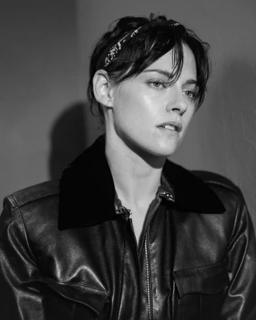 Black and white portrait of Kristen Stewart wearing a leather jacket and headband by photographer Pat Martin.