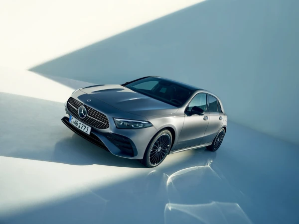 Sleek grey Mercedes-Benz A-Class hatchback showcased in a studio setting with patterned shadows enhancing its modern design.