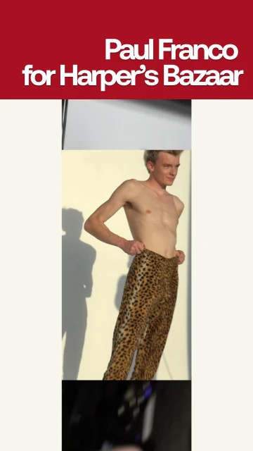 Fashion editorial features a shirtless adult male model wearing leopard-print pants, shot in a studio with a bright, neutral background.
