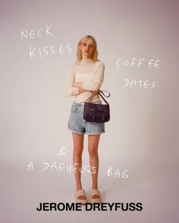 Fashion shot of a woman in denim shorts holding a satchel bag, posing indoors against a plain background with handwritten text overlay.