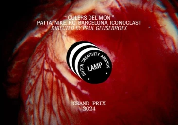 Close-up macro view of red organic muscle tissue with visible veins and central black and white circular award graphic text.