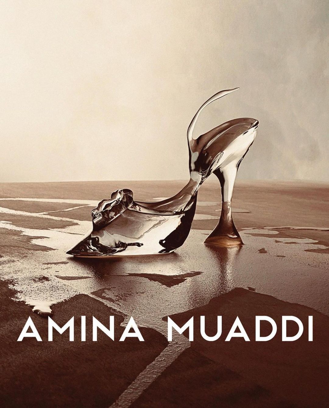 High heel shoe sculpture is displayed indoors with a liquid or resin-like aesthetic, under studio lighting, and against a gradient background.