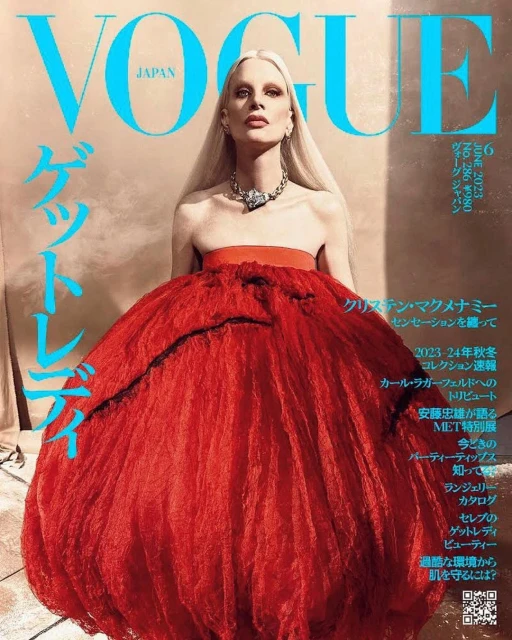 Vogue Japan cover featuring model Kristen McMenamy in a red tulle dress and diamond necklace, photographed in a studio setting.