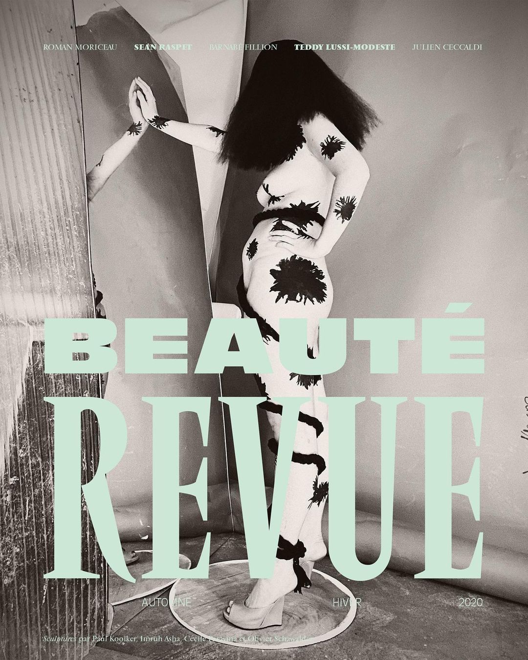 Beauty magazine cover featuring a female model with body paint, black hair, and platform shoes, alongside mint green typography.