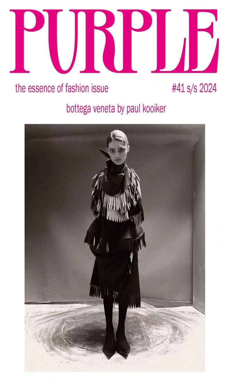 Magazine cover featuring a full-length portrait of a person wearing a Bottega Veneta fringe outfit, photographed by Paul Kooiker.