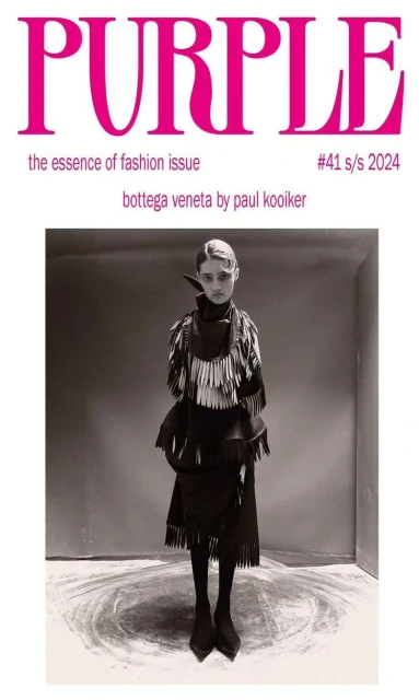 Magazine cover featuring a full-length portrait of a person wearing a Bottega Veneta fringe outfit, photographed by Paul Kooiker.