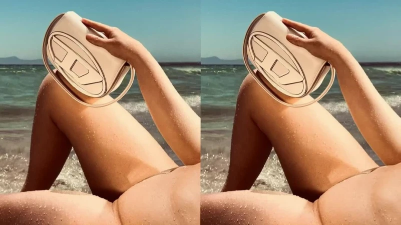 Fashion shot of a woman on a beach, holding a beige Diesel handbag, featuring sand, waves, and clear blue sky, creating a summery aesthetic.