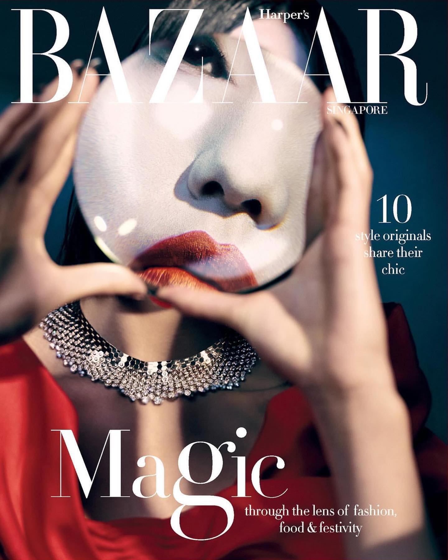 Harper's Bazaar Singapore cover featuring a woman's face reflected in a mirror held by her hands, wearing a jeweled necklace.