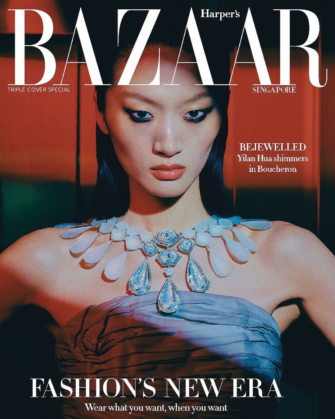 Harper's Bazaar Singapore cover featuring an Asian woman with heavy eye makeup and a large jeweled necklace against a red background.