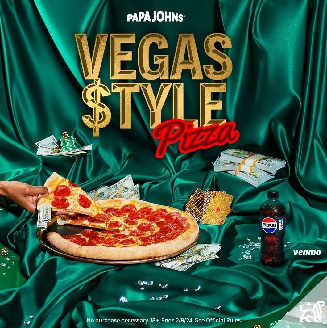 A pizza with pepperoni and a hand grabbing a slice, on a green draped table with money, chips, a Pepsi bottle, and casino props.