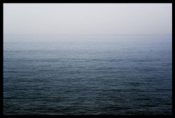 Calm ocean horizon meeting an overcast sky in a tranquil seascape photograph by Martin Vorel