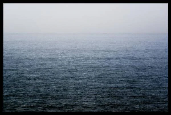Calm ocean horizon meeting an overcast sky in a tranquil seascape photograph by Martin Vorel