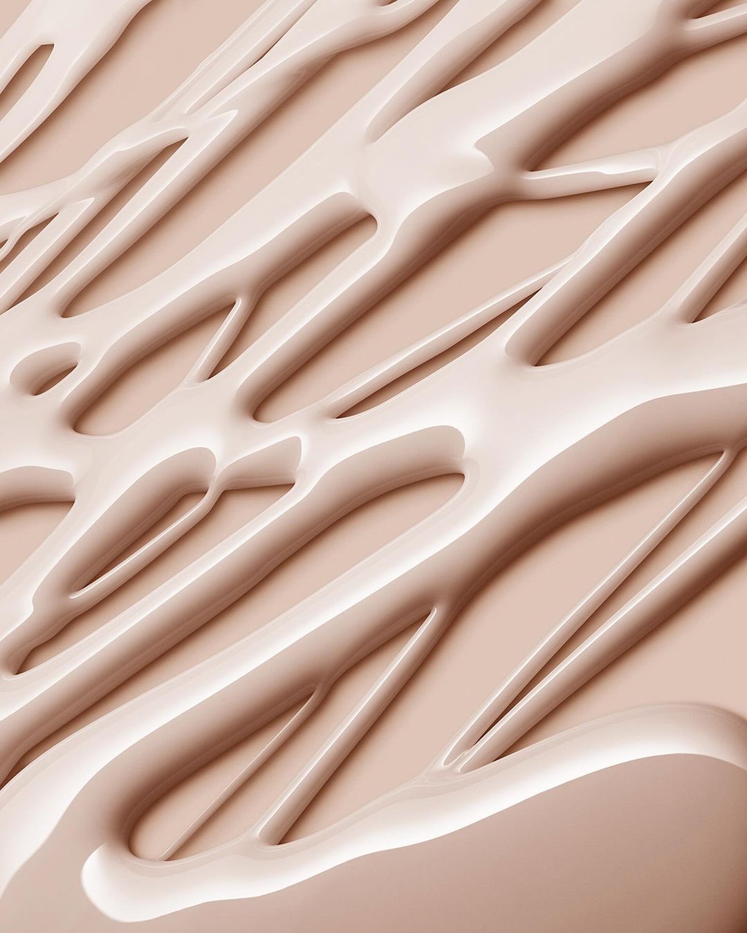 Abstract close-up of beige-toned cosmetic cream or liquid foundation with smooth, glossy texture and diagonal linear patterns.