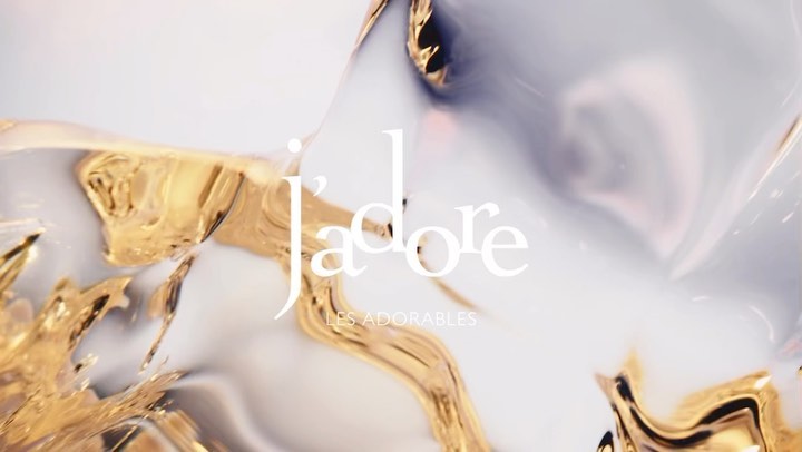 Abstract swirls of white, gray and gold create an elegant background with J'adore and Les Adorables typography in the foreground.