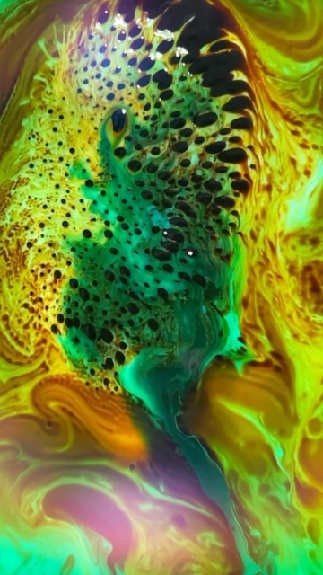Abstract swirl of green, yellow, and black ink with bubbled texture, resembling a fantastical or organic liquid pattern.