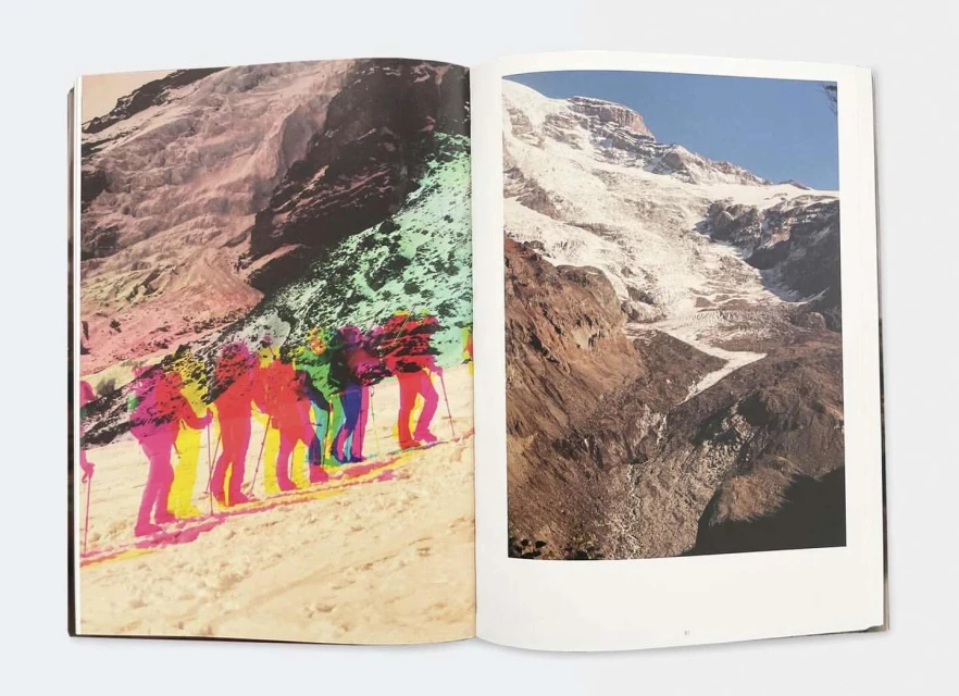 Open book features a colourful group of hikers climbing a snow-covered mountain with blue sky; opposite page shows a glacier-covered mountain.