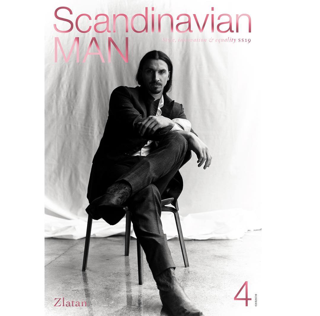 Zlatan Ibrahimović poses on a chair in a black-and-white magazine cover photo for Scandinavian Man, wearing a blazer and dark pants.