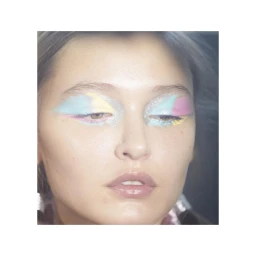 Close-up portrait of a woman with pastel eyeshadow and silver glitter makeup by photographer Peter Gehrke